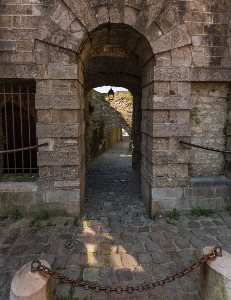 a stone archway with a chain hanging from it